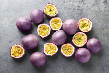 Fresh passion fruits on grey table, flat lay