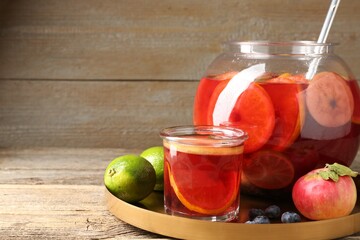 Tasty punch and fruits on wooden table, closeup. Space for text