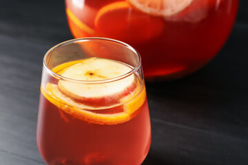 Fruity punch on black wooden table, closeup. Refreshing drink