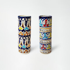 Two decorative ceramic vases with intricate colorful patterns and figures
