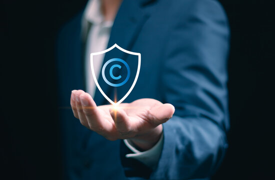 Copyright or patent concept, man hand holding copyright icon with shield, Copyleft trademark license, Creation ownership against piracy crime