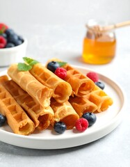 Waffle rolls with berries and honey