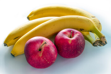 A bunch of apples and bananas on a white background.