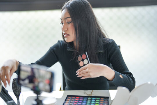 Beauty influencer Asian girl Using Social Media for live streaming on Smartphone online audience like and subscribe to her channel. Like, Follower, Comment