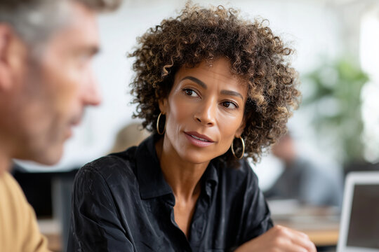 Manager conducting performance review with employee in professional setting, 