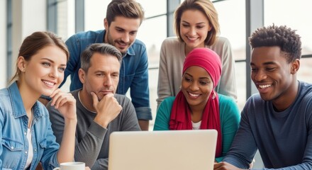 A diverse group of people working together on a laptop in an office setting.