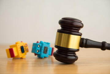 Hammer judge gavel and AI artificial intelligence bot falling down on wooden table with white wall background copy space. Artificial intelligence AI governance, law, regulation, act concept.