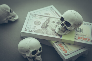 Stack US dollar banknotes with skulls. Dedollarisation concept. Countries dumping the US dollar, reduce their reliance on the US dollar as medium of exchange, a reserve currency and unit of account.