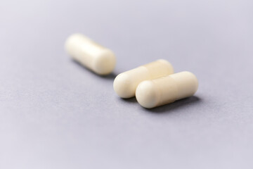 Creatine tablets on paper background. Soft focus. Close up. Copy space.	