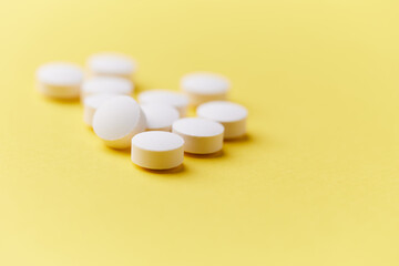 Hyaluronic acid tablets. Hyaluronic acid helps skin stretch and flex and reduces skin wrinkles. Bright paper background. Soft focus. Close up. Copy space	