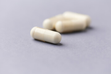 Creatine tablets on paper background. Soft focus. Close up. Copy space.	
