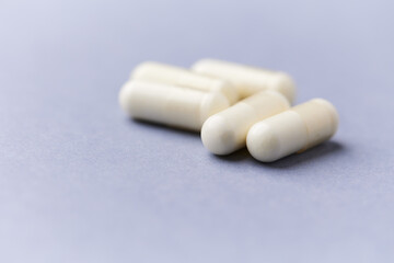 Creatine tablets on paper background. Soft focus. Close up. Copy space.	