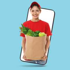 Delivery service worker giving order out of mobile phone against light blue background. Woman with paper bag full of food products © New Africa