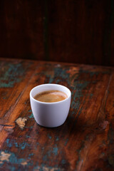Cup of coffee on rustic wooden background. Soft focus. Copy space	