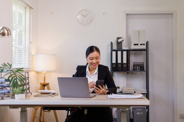 Portrait of laughing business asian woman sitting at desk in the office, financial report, business plan investment, finance analysis concept.
