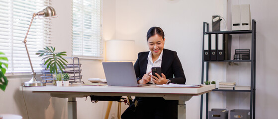 Portrait of laughing business asian woman sitting at desk in the office, financial report, business...