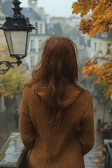 Woman standing on rain-soaked bridge.