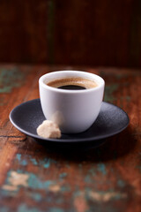Cup of coffee on rustic wooden background. Soft focus. Copy space	