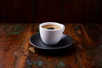 Cup of coffee on rustic wooden background. Soft focus. Copy space	