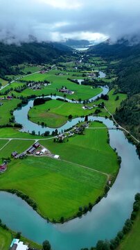Experience the breathtaking beauty of Stryn, Norway with its vibrant valleys, winding rivers, and idyllic farms. This picturesque landscape captures the essence of Norwegian nature and tranquility.
