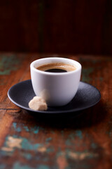Obraz premium Cup of coffee on rustic wooden background. Soft focus. Copy space 