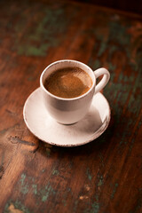 Cup of coffee on rustic wooden background. Soft focus. Copy space	
