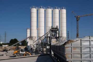 Scenery of concrete factory with white silos for production of concrete	