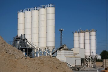 Scenery of concrete factory with white silos for production of concrete	