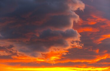 Dramatic burning colorful clouds in beautiful sunset sky background
