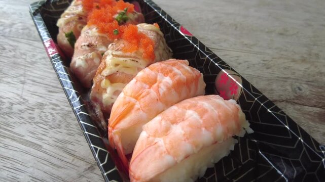 Four pieces of Japanese sushi served in a plastic box for those who want to buy it to take home for dinner.