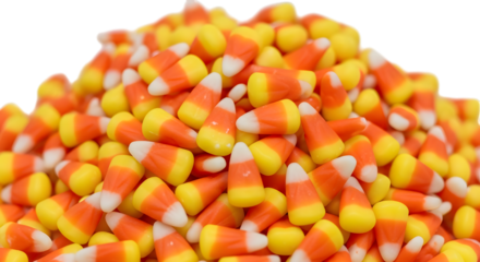A large pile of candy corn, a popular halloween candy, isolated on transparent background