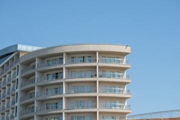 Curved Balcony Building Exterior Under Blue Sky