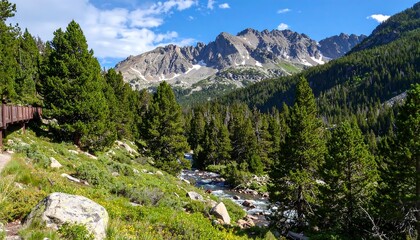 Fototapeta premium A vibrant mountain landscape, featuring a winding stream cascading through a verdant valley. 
