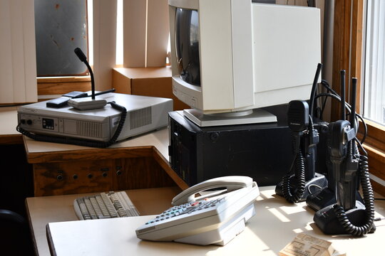 Old Motorola radios at guard station. Computer and phone sitting on desk. 
