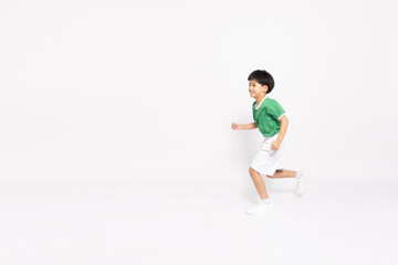 Happy Asian cute little boy in a green sports jersey running so fast isolated on white background