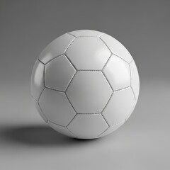 A white soccer ball rests on a plain grey background in a studio photograph