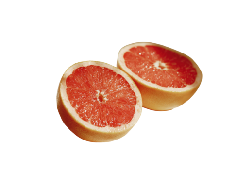 Two halves of a pink grapefruit, close-up.  Juicy segments are visible within the sections.  Soft lighting highlights the fruit's texture