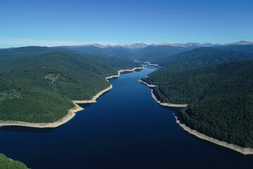 Aerial drone panorama view of Vidraru lake in Fagaras mountains, Romania.