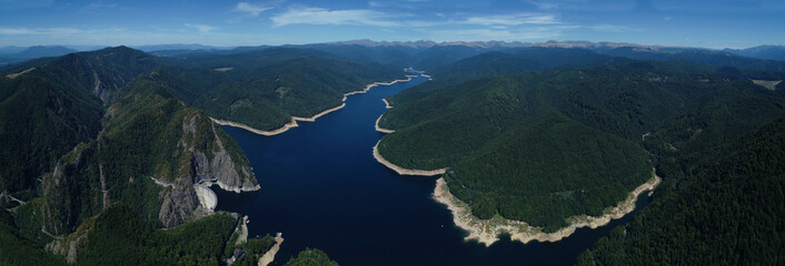 Aerial drone panorama view of Vidraru dam and lake in Fagaras mountains, Romania.