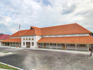 Historic Dutch colonial school building in Indonesia with red-tiled roof and classic architecture. The preserved structure showcases cultural heritage and the nation&rsquo;s educational past.