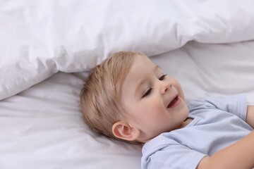 Cute little baby on bed at home