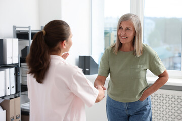 Fototapeta premium Cooperation and teamwork. Women shaking hands in office
