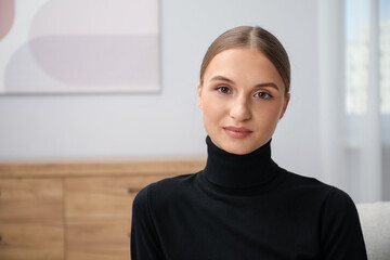 Portrait of positive elegant woman at home. Space for text