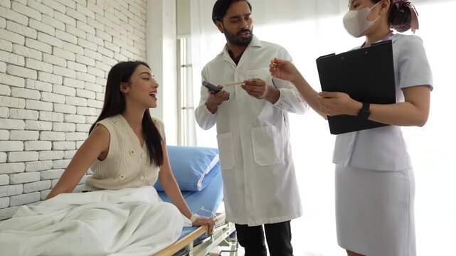 A physician performs an oropharyngeal examination on a patient, using a tongue depressor and penlight to assess for pharyngitis, tonsillitis, or other oral pathologies.