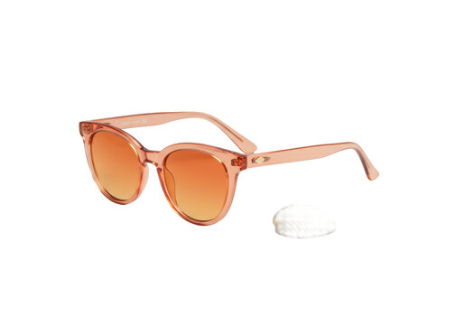 Elegant cat-eye sunglasses with translucent tangerine frames and gradient orange lenses next to a transparent seashell on a transparent background, concept of elegant product display