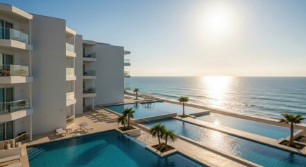 Obraz premium Modern Coastal Hotel with Infinity Pools and Ocean View at Sunset