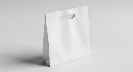 White paper shopping bag with diecut handle isolated on white background