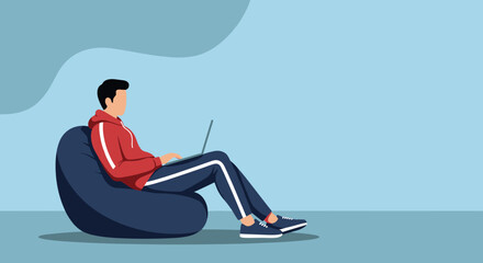 Young man comfortably works or studies on a laptop from a bean bag chair. Represents flexible work, online learning, and modern digital lifestyle.