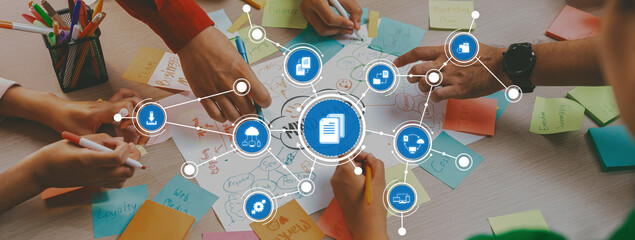 Professional startup group share creative marketing idea by using mind map. Young skilled business people brainstorm business plan while writing sticky notes. Focus on hand. Closeup. Variegated. Amity