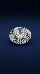 Sparkling oval cut diamond gleams brilliantly on a deep blue textured background